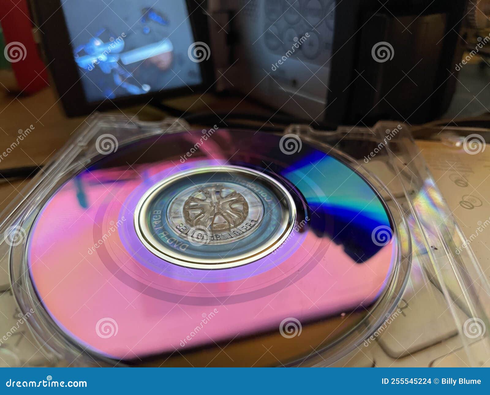 Vintage Mini DVD Disk in a Case and Camera Blurred Screen Stock Photo