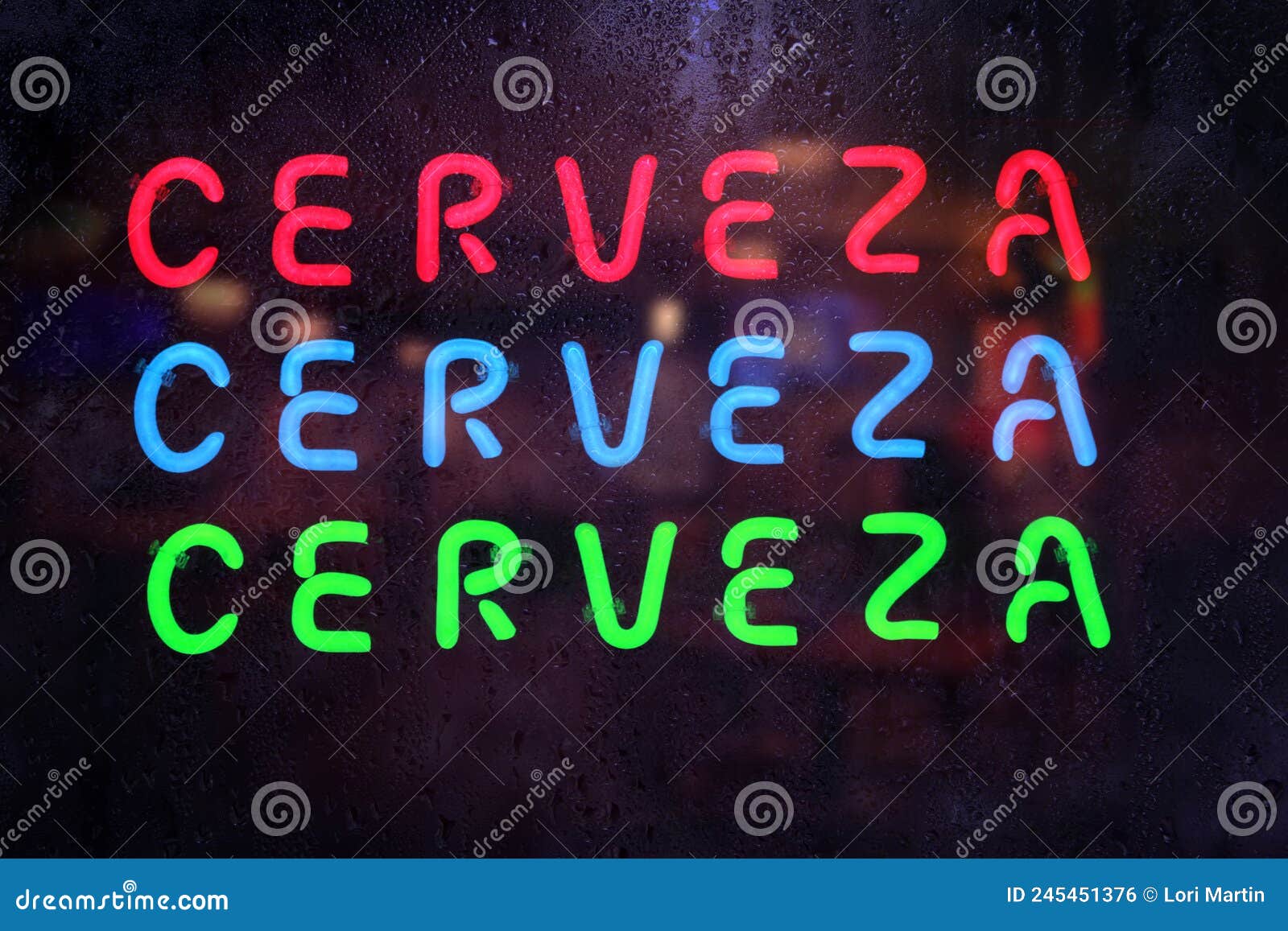 vintage neon cerveza sign in rainy window - cerveza is spanish for beer