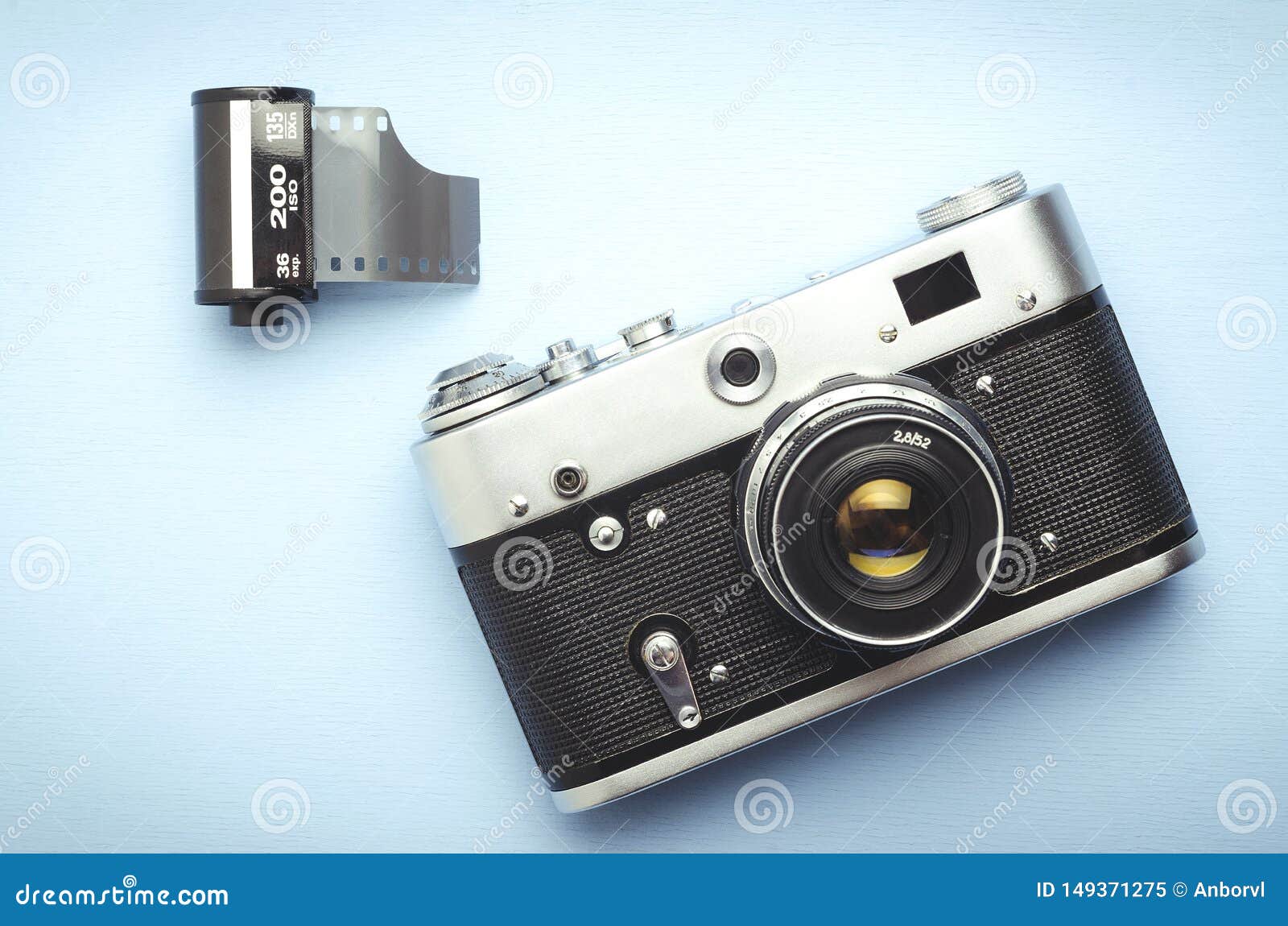 Vintage Old Film Camera and a 35mm Reel of Film on a Blue Background Stock  Image - Image of black, perforation: 149371275