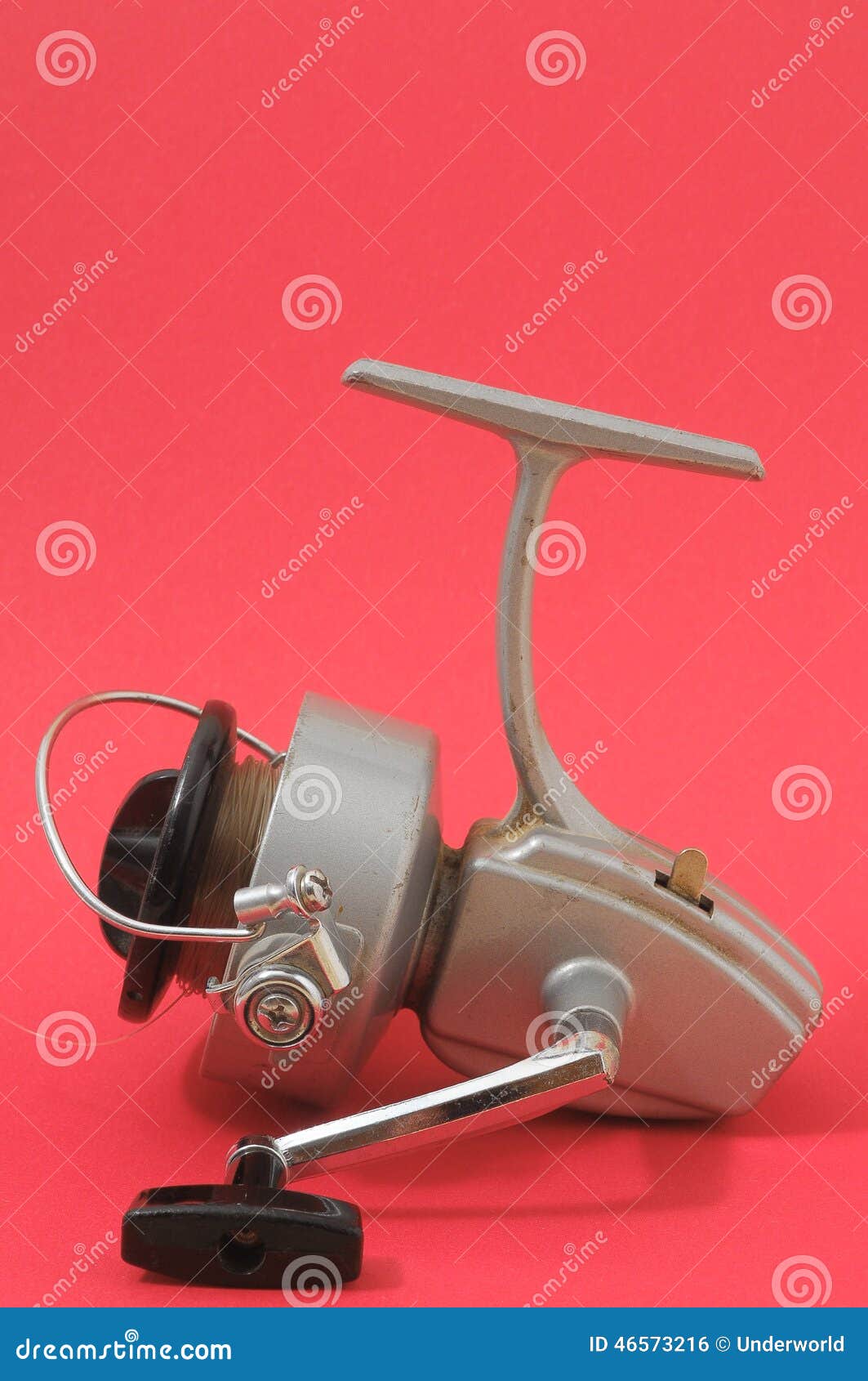 One Vintage Old Fishing Reel On A Colored Background Stock Photo