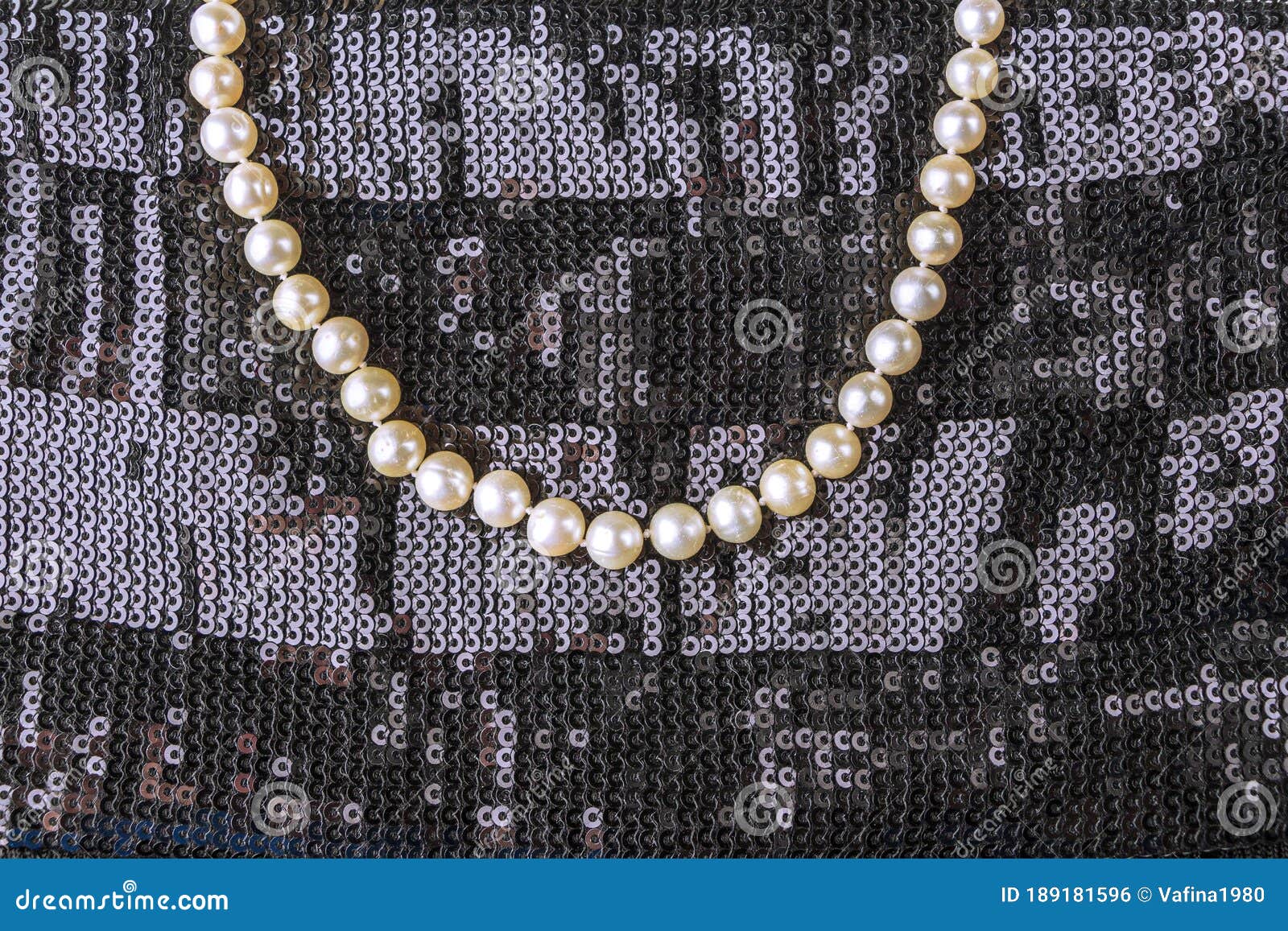 black dress with pearl jewelry