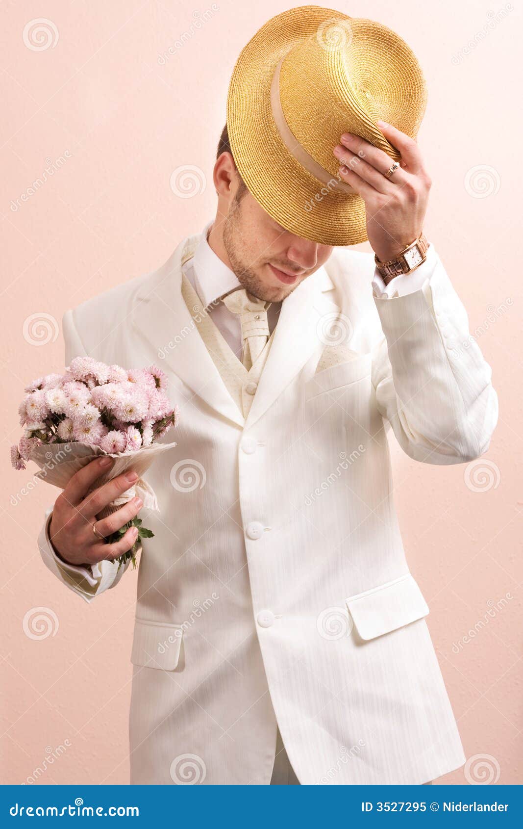 Vintage portrait of groom. Young groom in wedding wear with bouquet of chrysanthemum. Special pink toned photo f/x