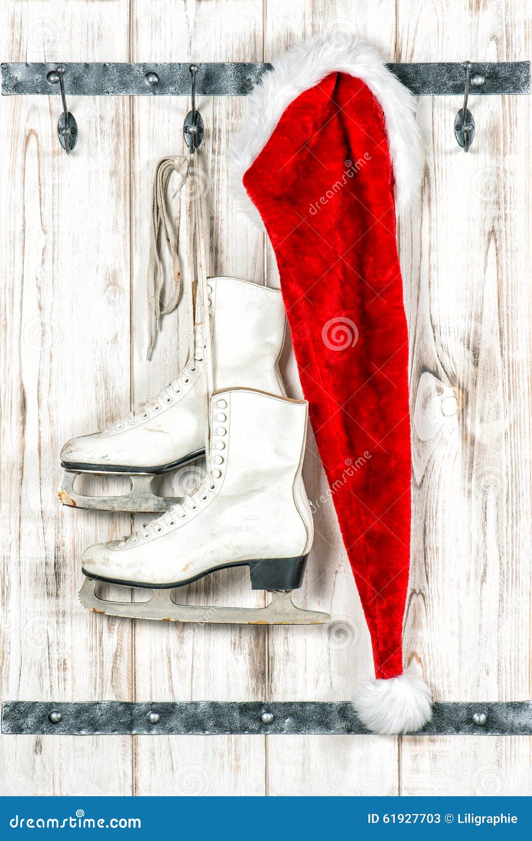 vintage style christmas decoration red santa claus hat santas white ice skates over rustic wooden background 61927703