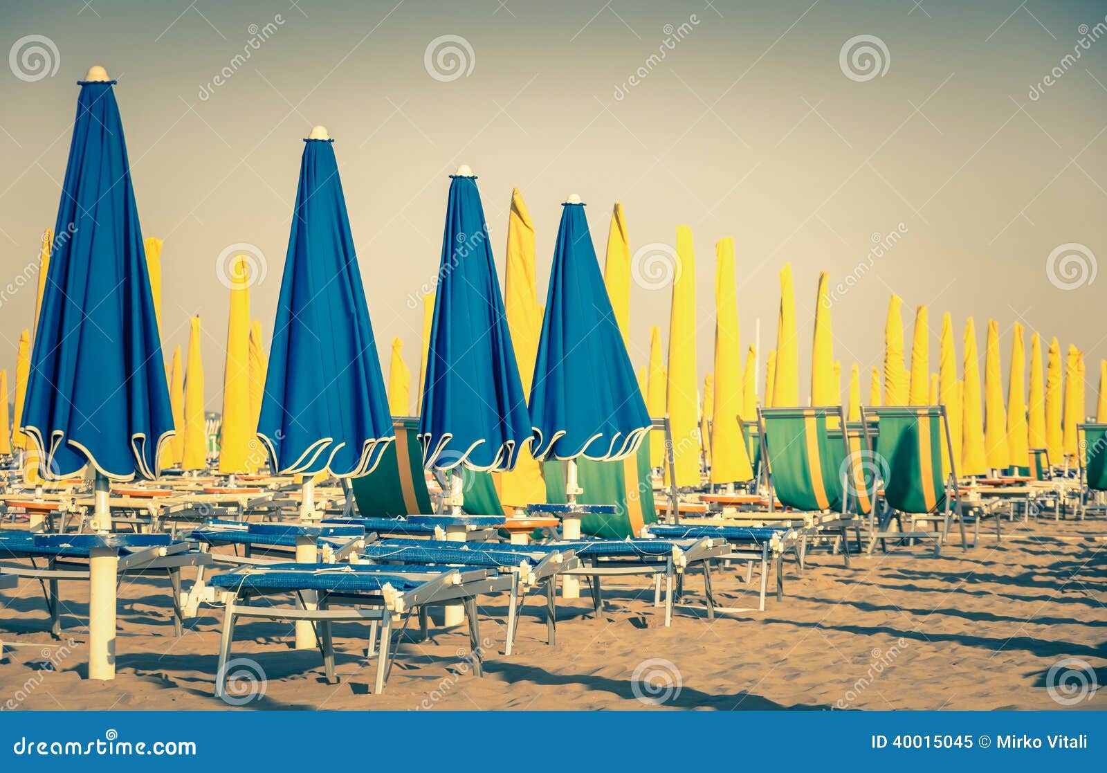 vintage umbrellas and sunbeds at rimini beach italy