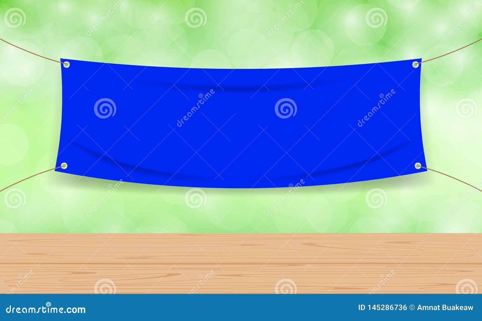 vinyl blank blue on green bokeh background and wood plank table, mock up textile fabric empty for banner advertising stand hanging