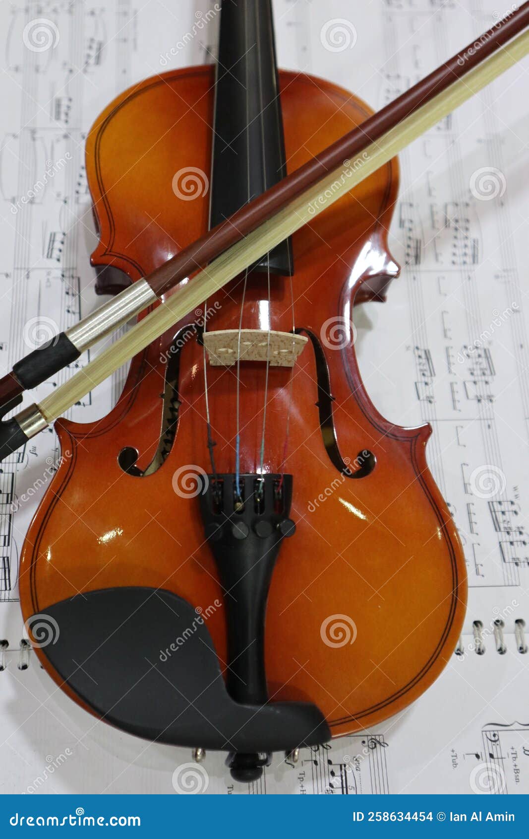 violin and bow with music partiture background