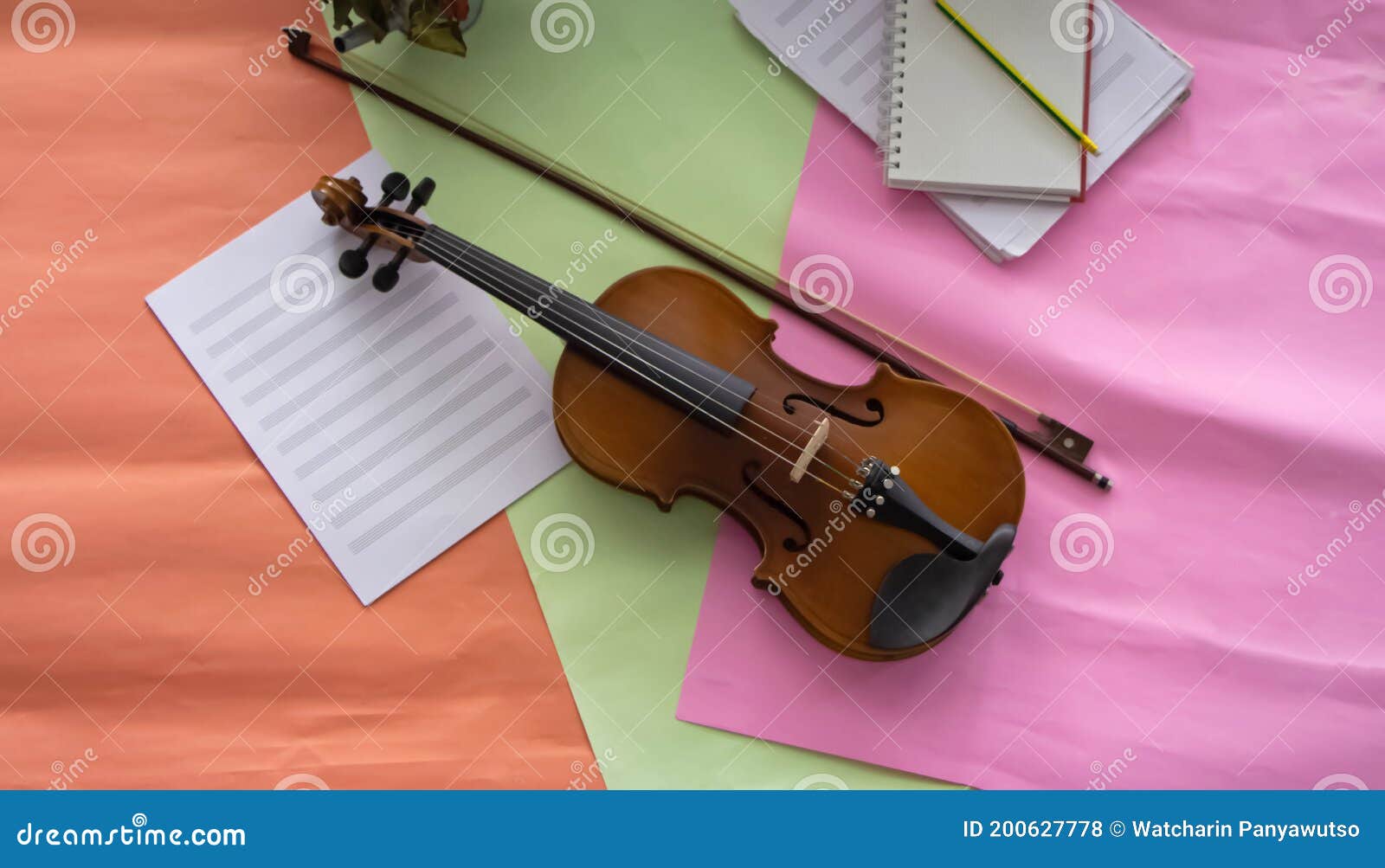 violin and bow put on colorful background