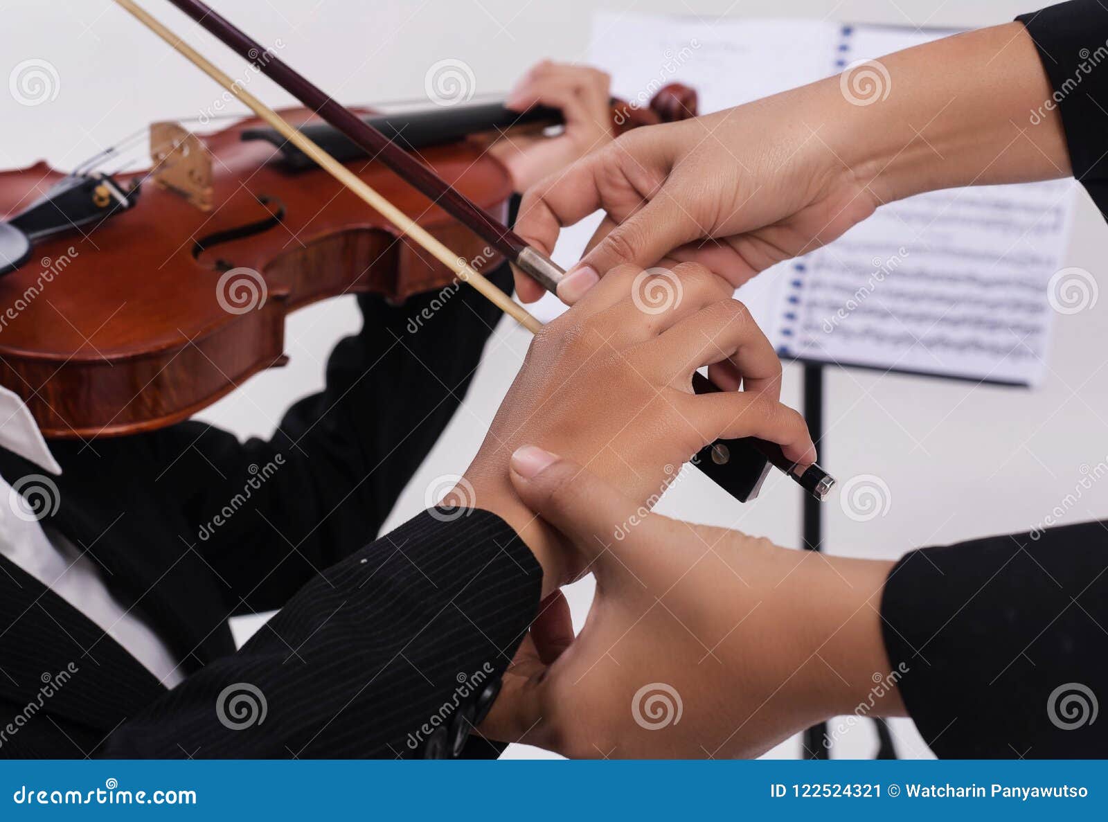 The Violin Teacher Hands is Teaching the Violin Student,by Touch