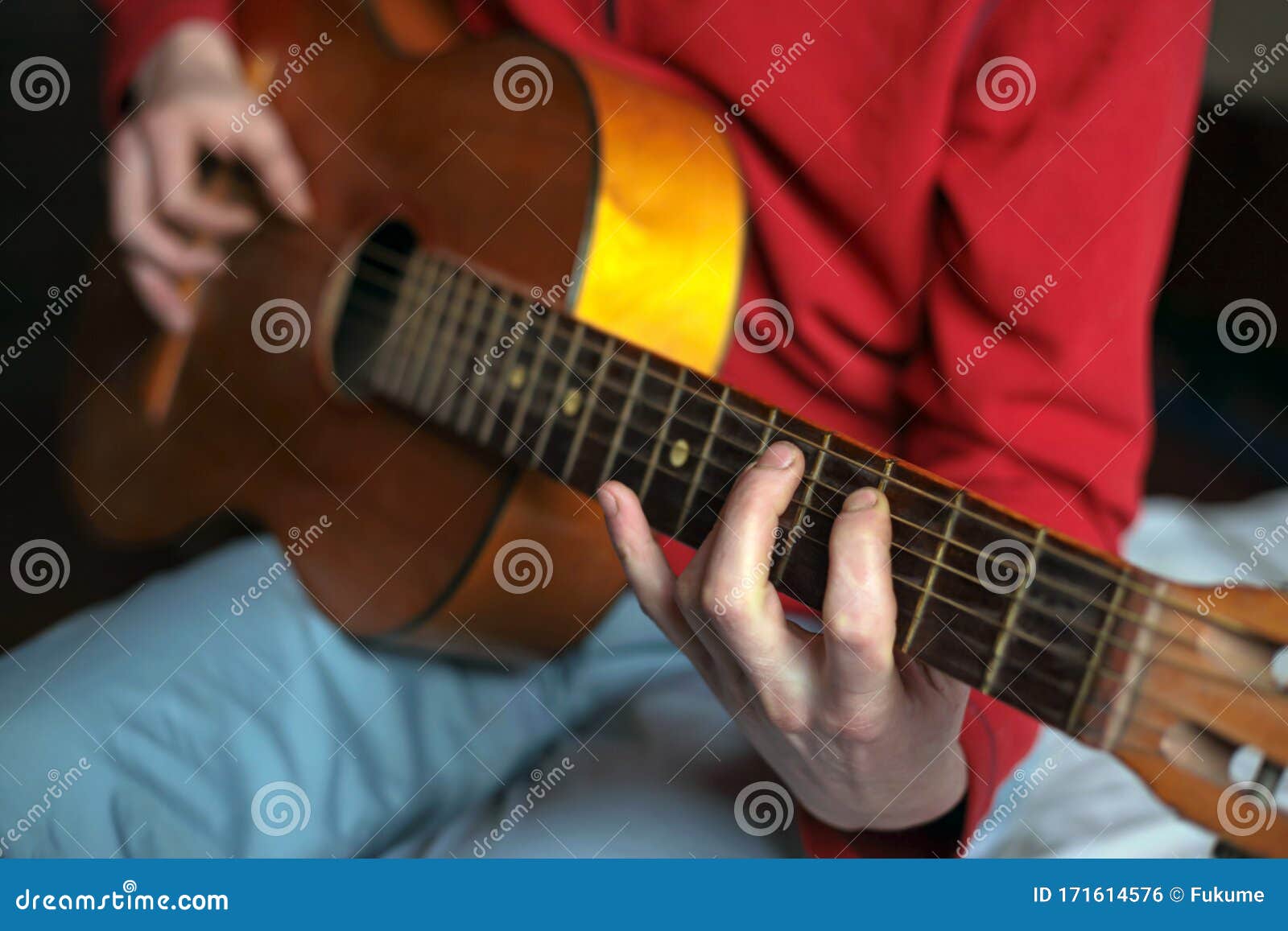 virtuoso guitarist playing his acoustic guitar