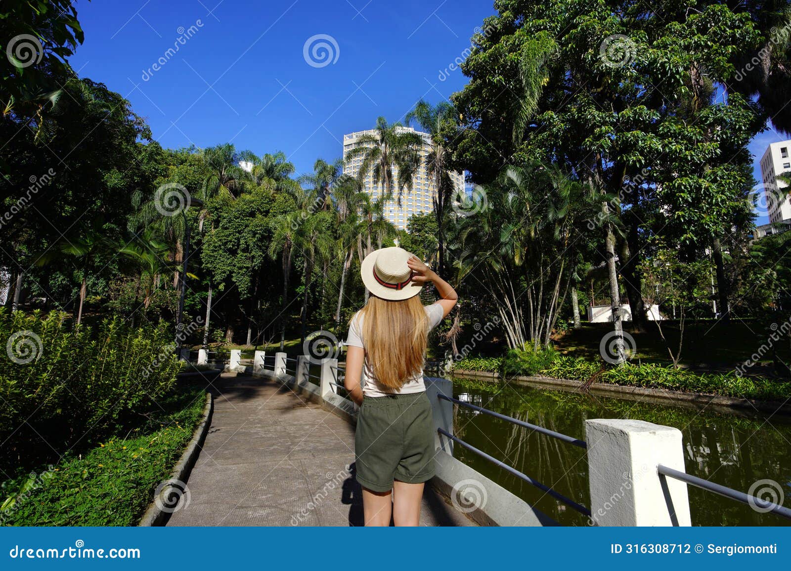 visiting belo horizonte, brazil. back view of young woman in the municiapl parque americo renne giannetti, a city park in belo