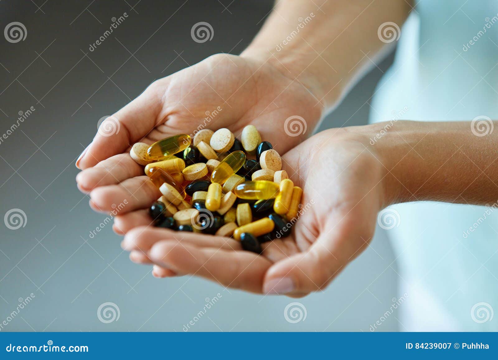 vitamins and supplements. woman hands full of medication pills