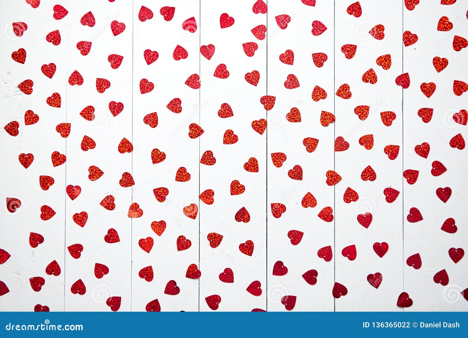 vlentine`s day composition. heart d sequins placed on white wooden table
