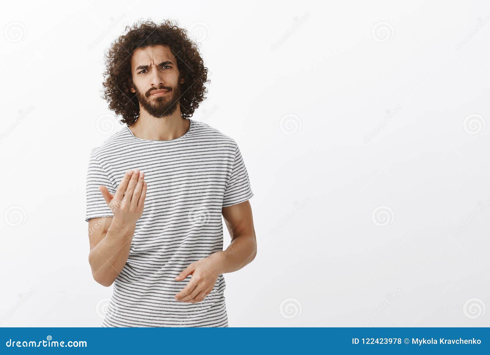 Um homem sério e bonito com cabelo encaracolado e camisa xadrez