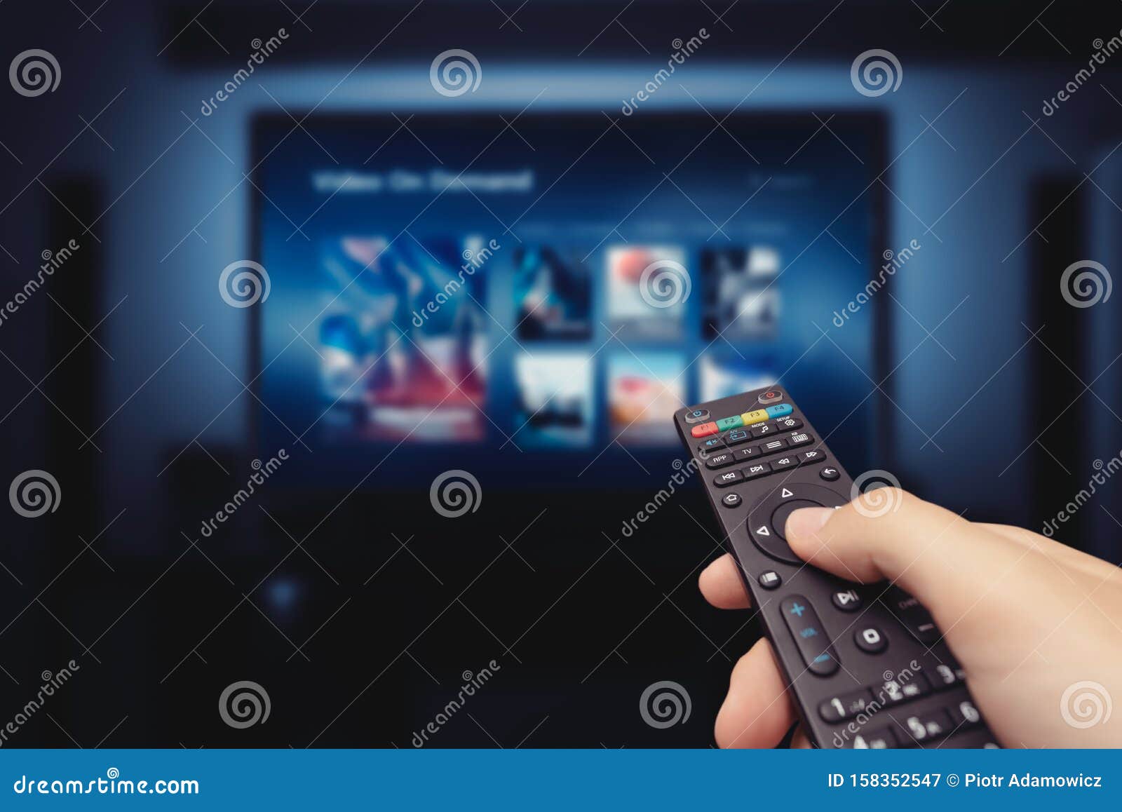VOD Service Screen with Remote Control in Hand Stock Image