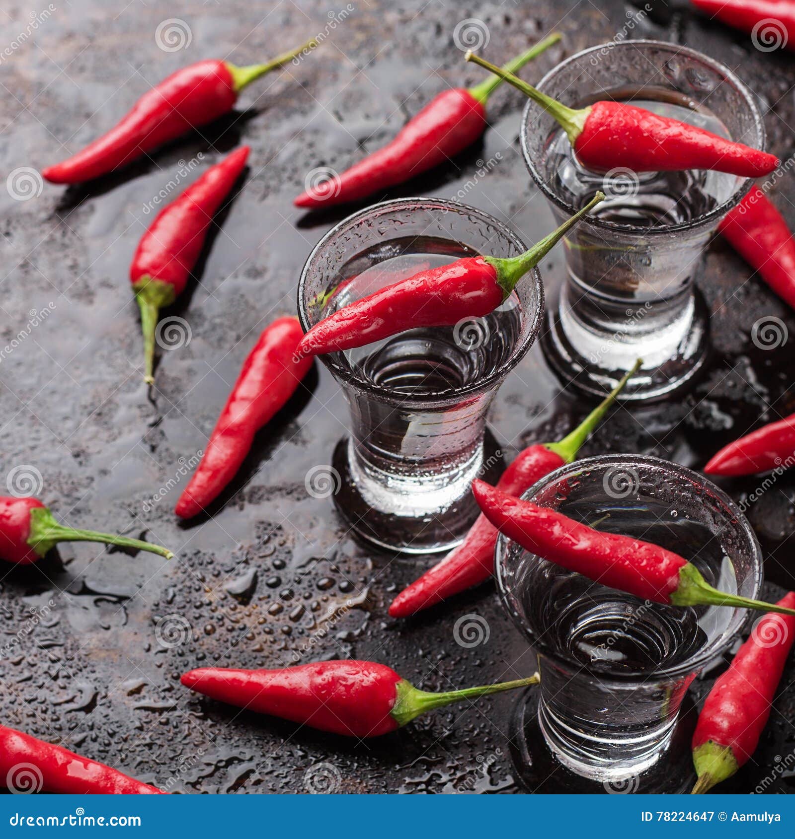 vodka with chili peppers on rusty grunge table