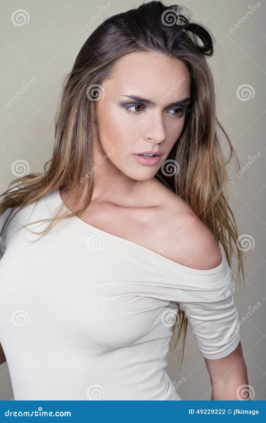 vogue style portrait of beautiful delicate woman on  brown background - perfect skin. professional make-up