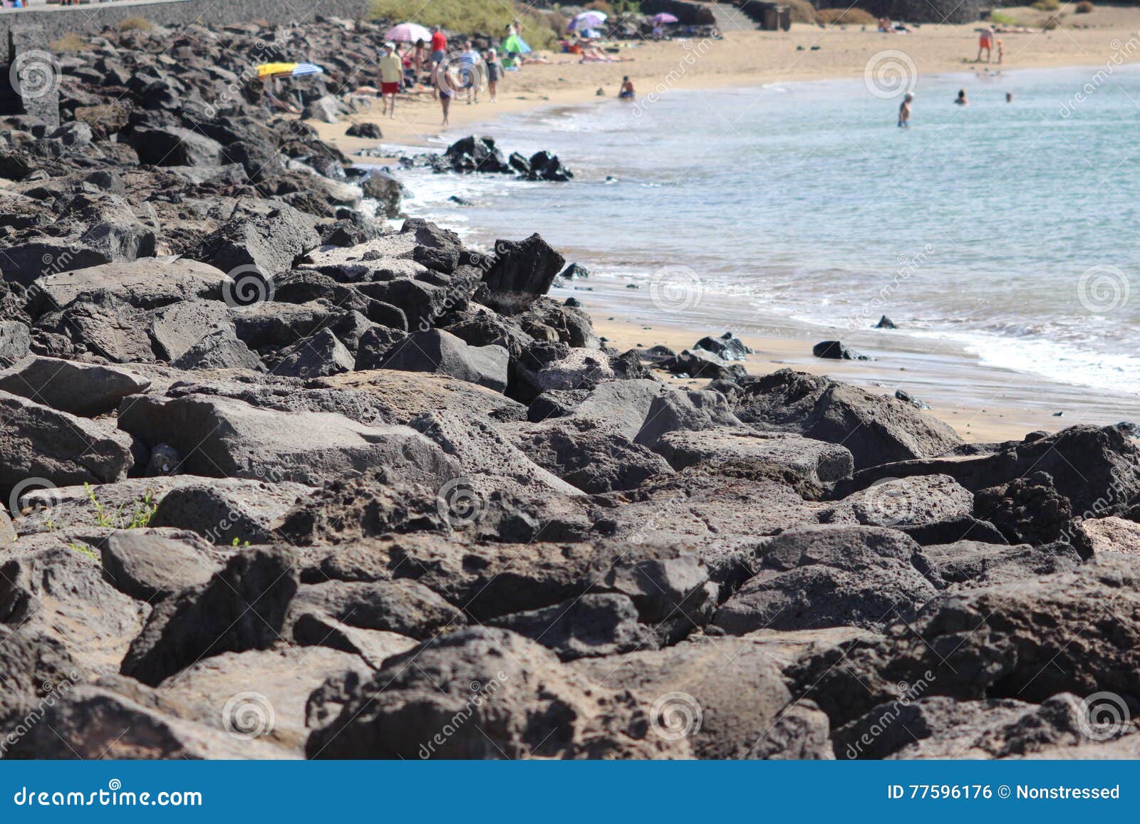 a volcanic coast and sandy beach