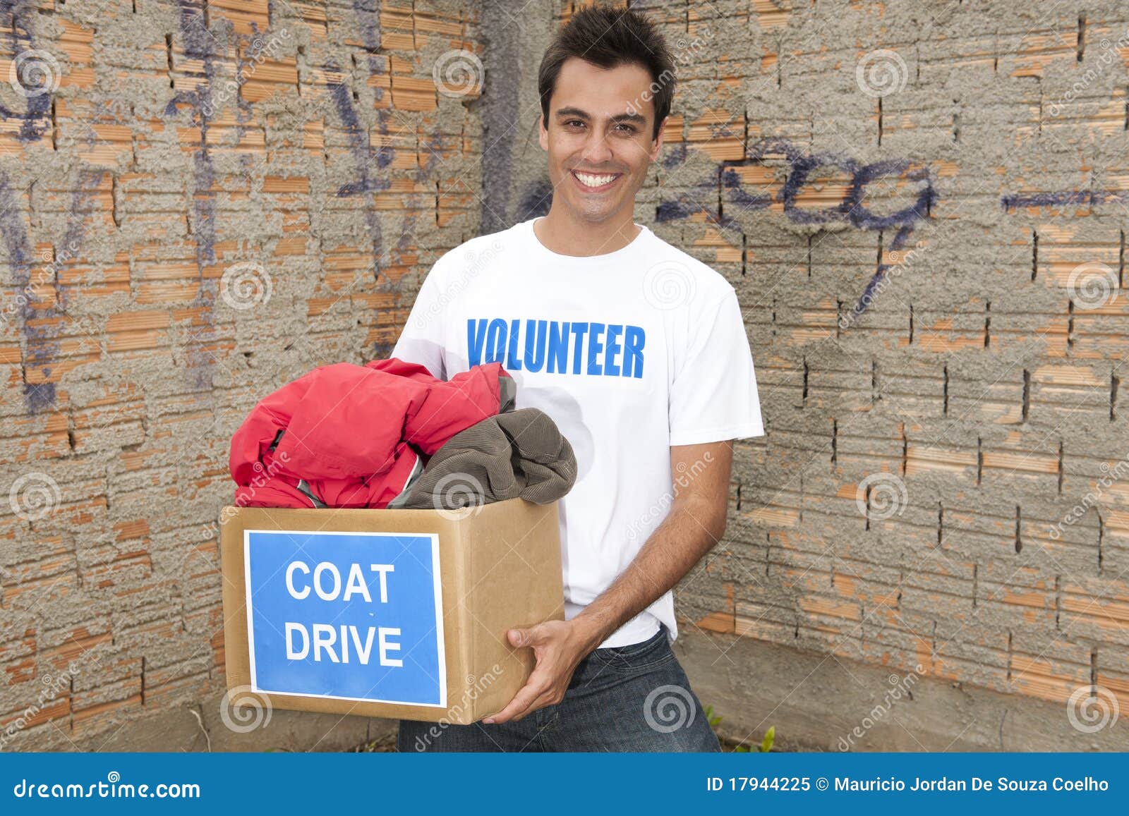 volunteer with coat drive donation box