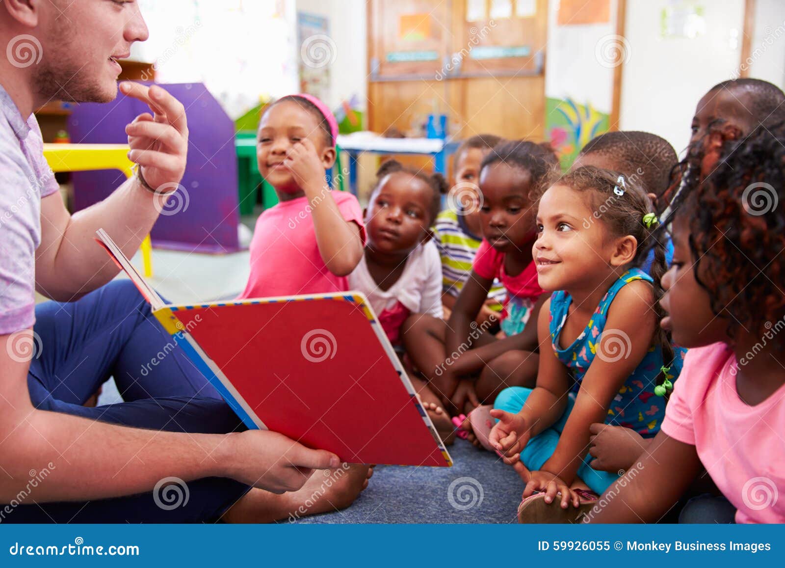 volunteer teacher reading to a class of preschool kids