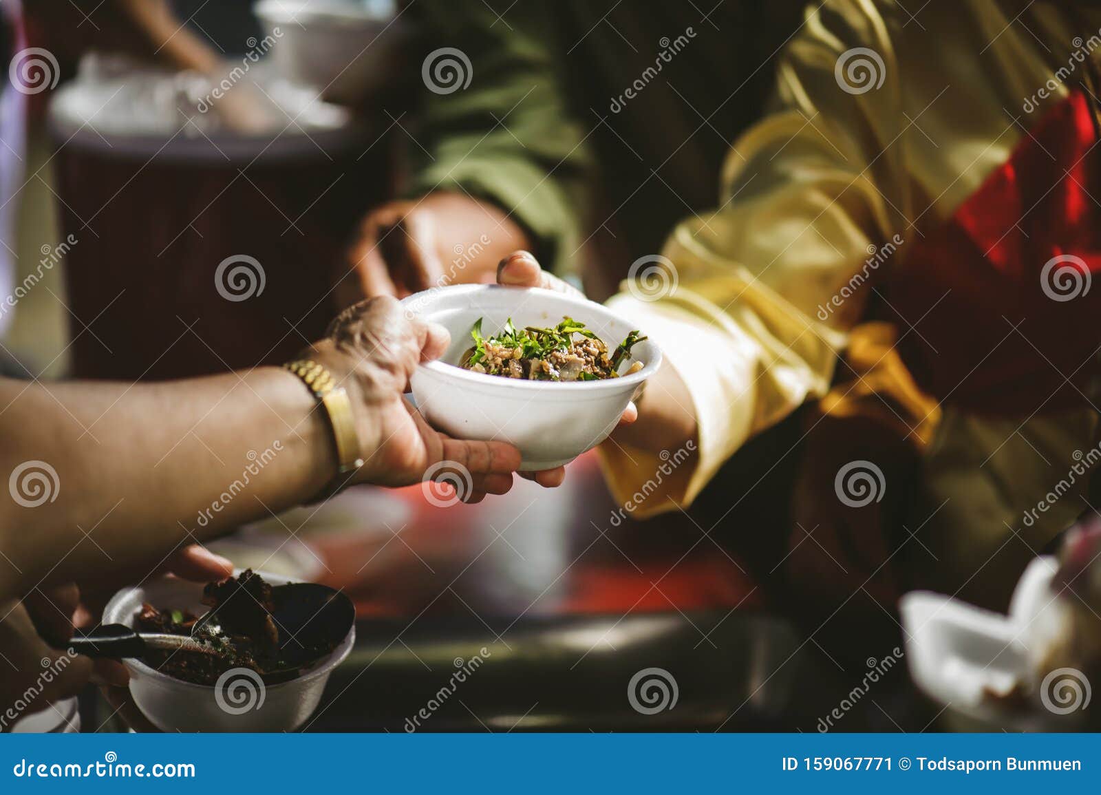 volunteers serving food for poor people : concept of free food serving