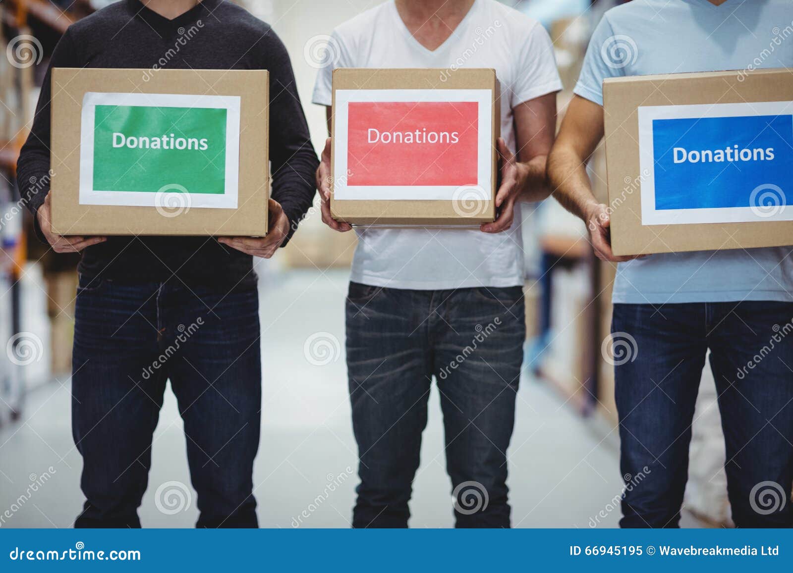 Volunteers Smiling at Camera Holding Donations Boxes Stock Image
