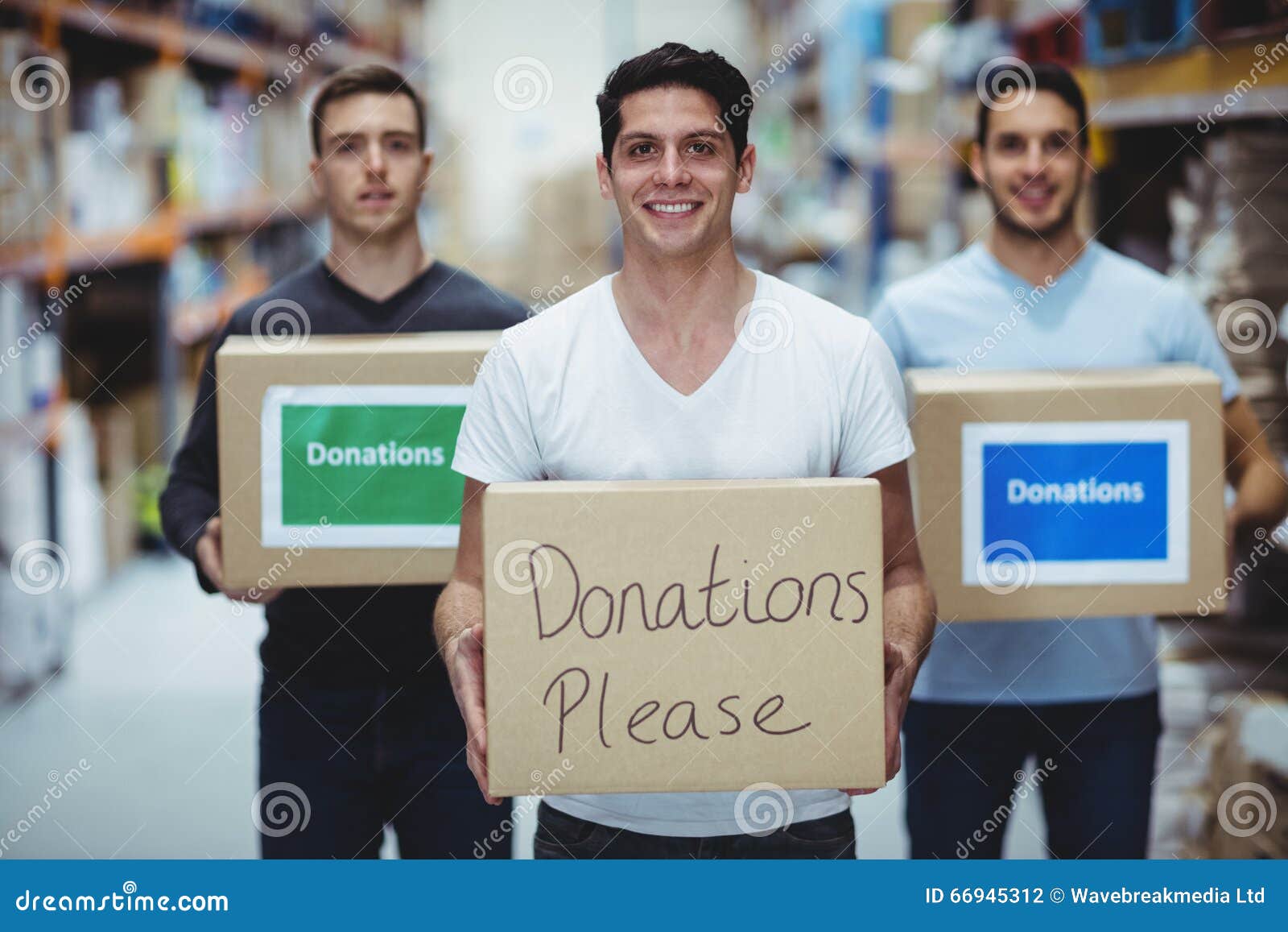 Volunteers Smiling at Camera Holding Donations Boxes Stock Photo