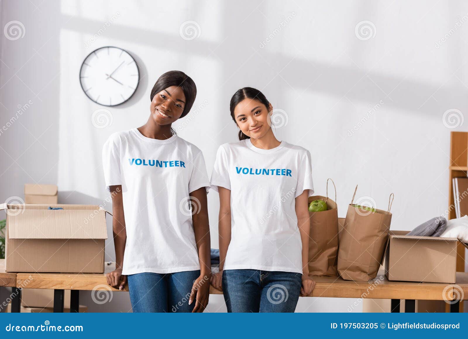 Volunteers Smiling at Camera Near Donations Stock Image Image of