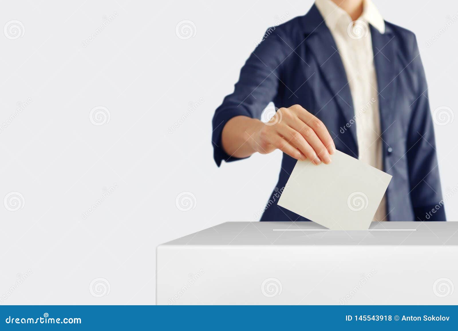 voting. woman putting a ballot into a voting box