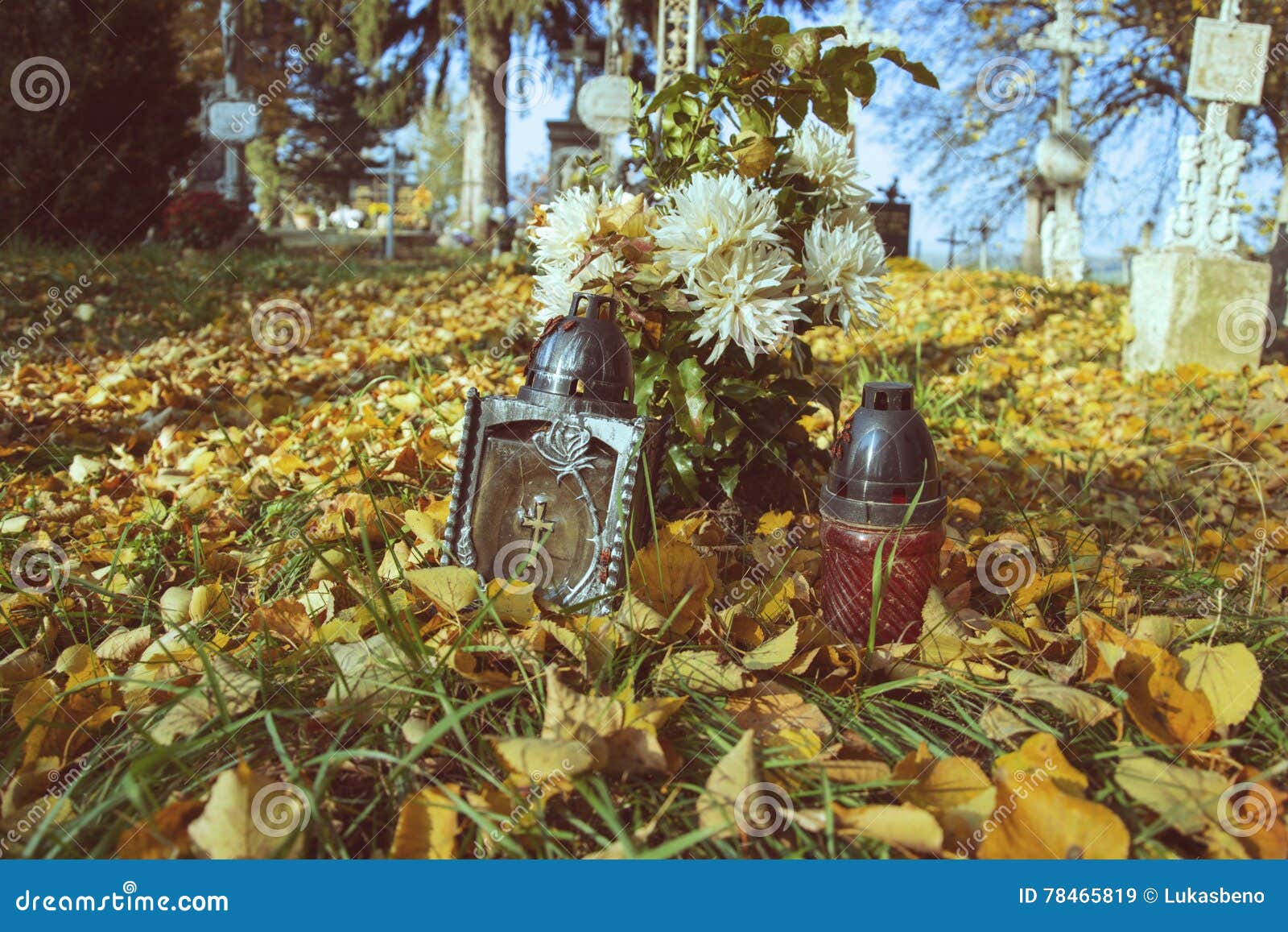 votive candles lantern on the grave in slovak cemetery. all saints' day. solemnity of all saints. all hallows eve