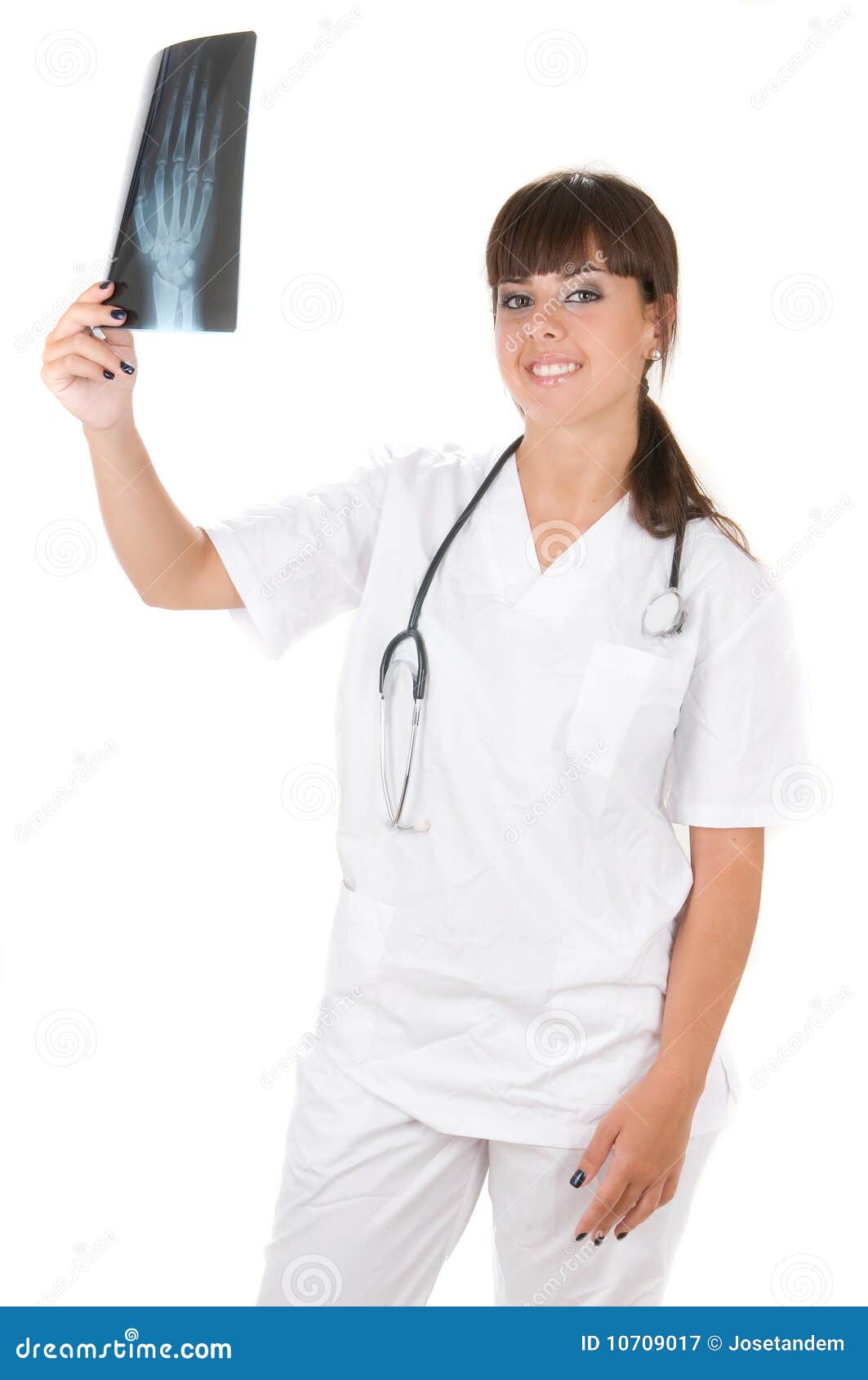 Vrouwelijke arts die een xray beeld in wit onderzoekt