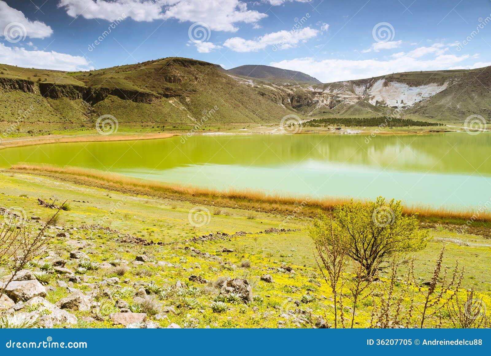 vulcanic lake with blue sky and clouds
