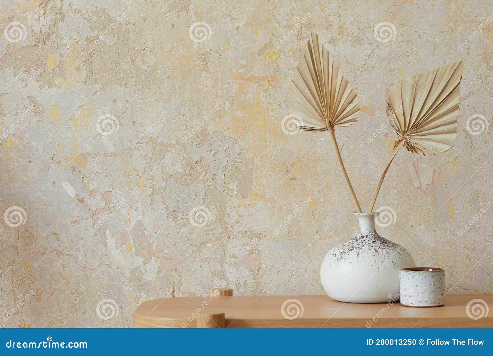 wabi sabi interior of living room with wooden console, paper flowers in vase, accessories and copy space. minimalistic concept.