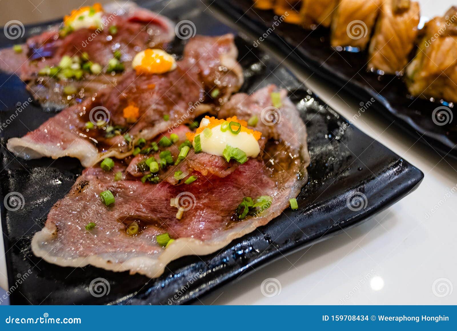 wagyu sushi serve on black dish