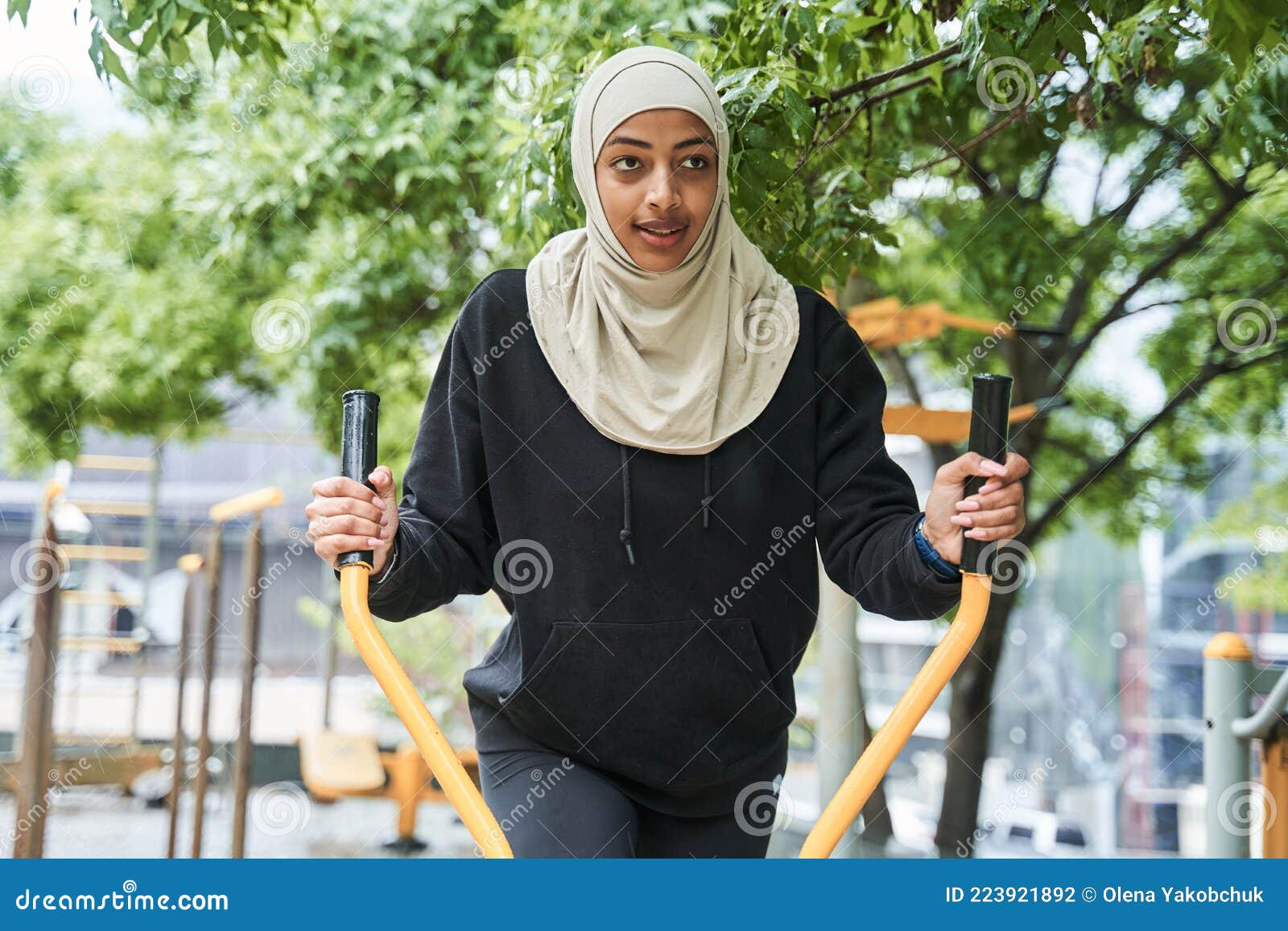 Woman with Muslim Sport Wear Stretching and Training at the