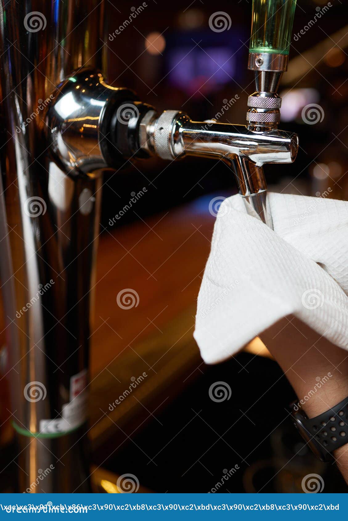 Waiter or Bartender Cleaning Beer Taps on the Counter in Pub and