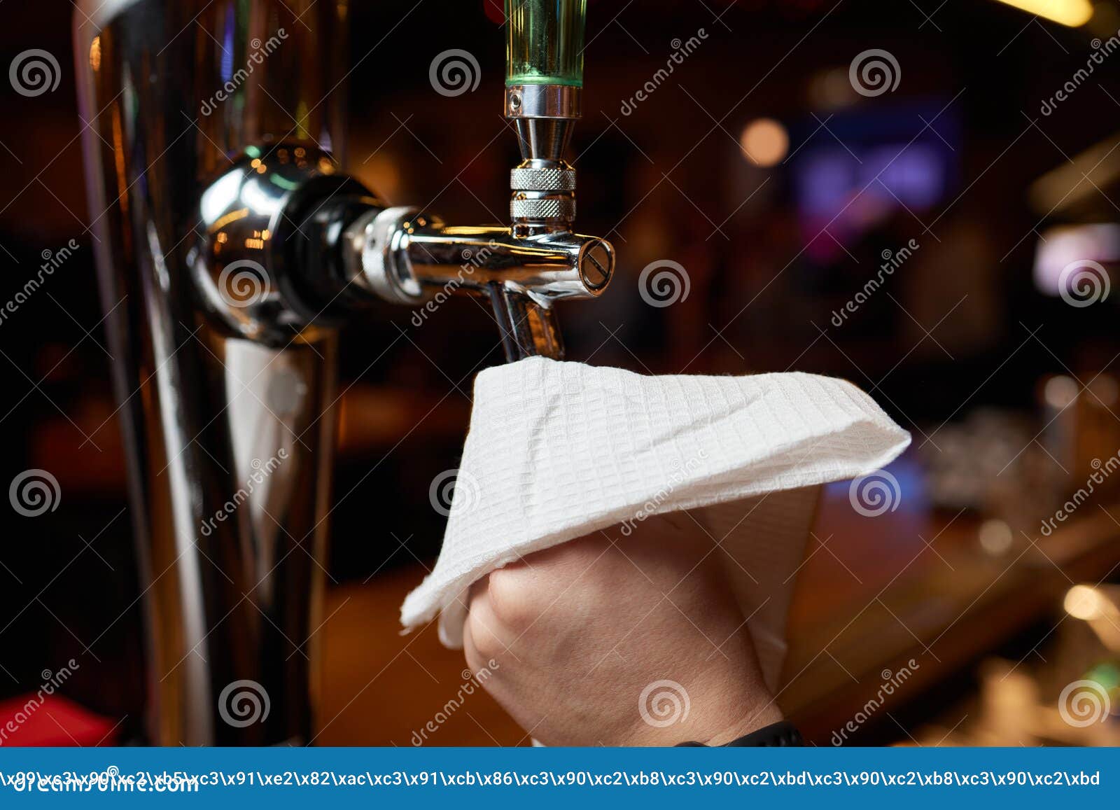 Waiter or Bartender Cleaning Beer Taps on the Counter in Pub and