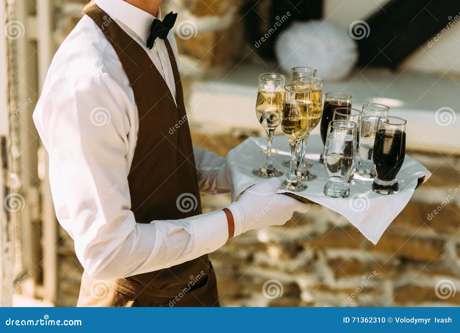 Waiter is Holding a Server with the Alcohol Drinks Stock Photo Image