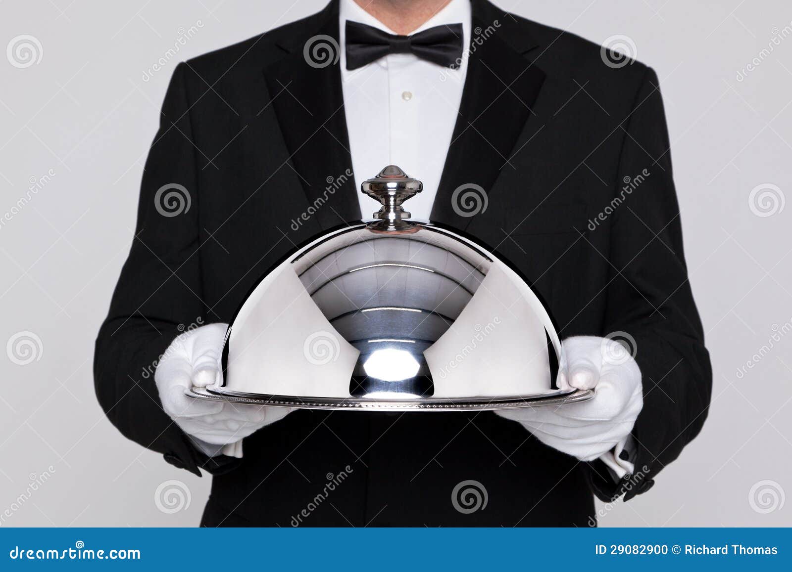 waiter holding a silver cloche