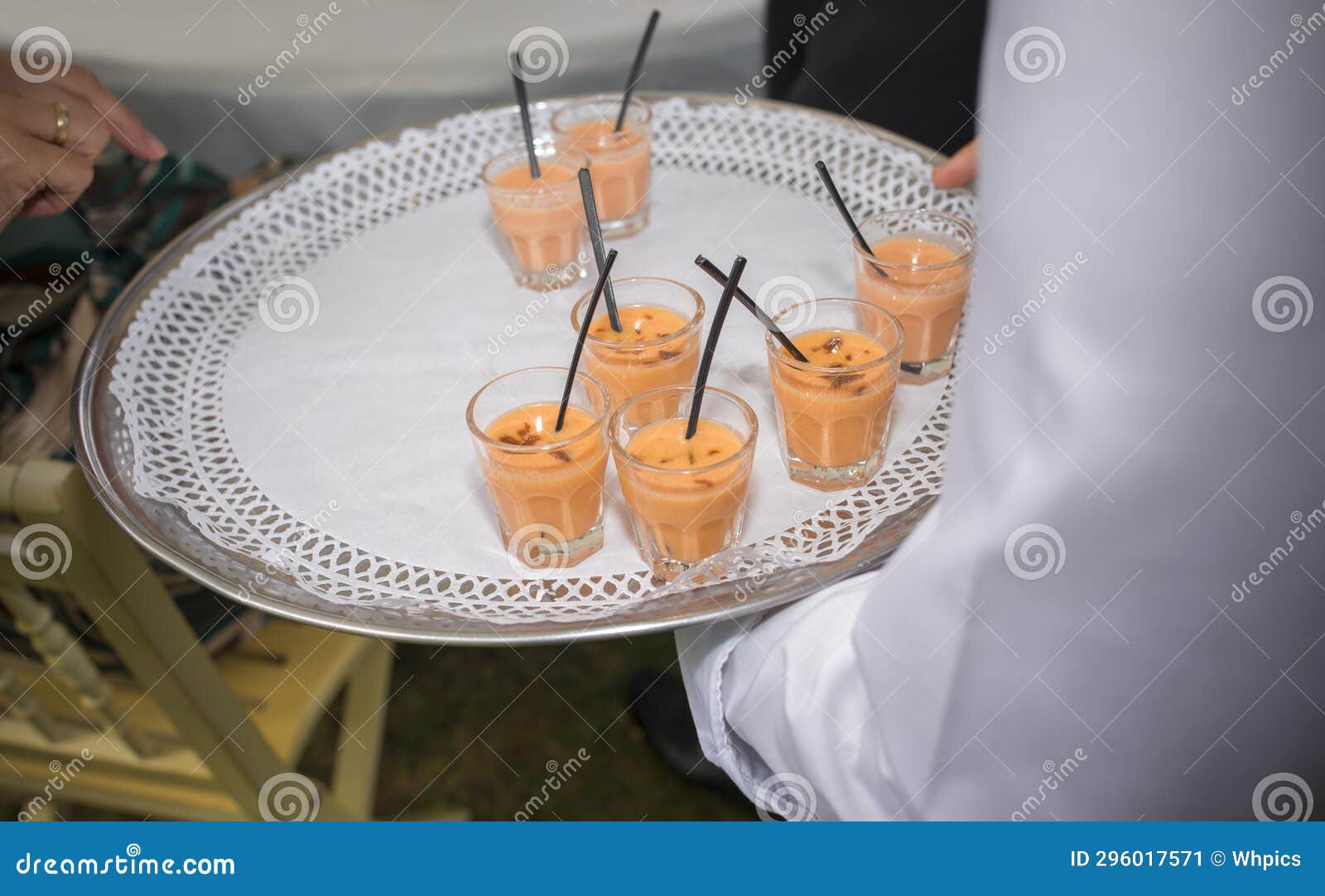 waiter offering gazpacho and salmorejo shots