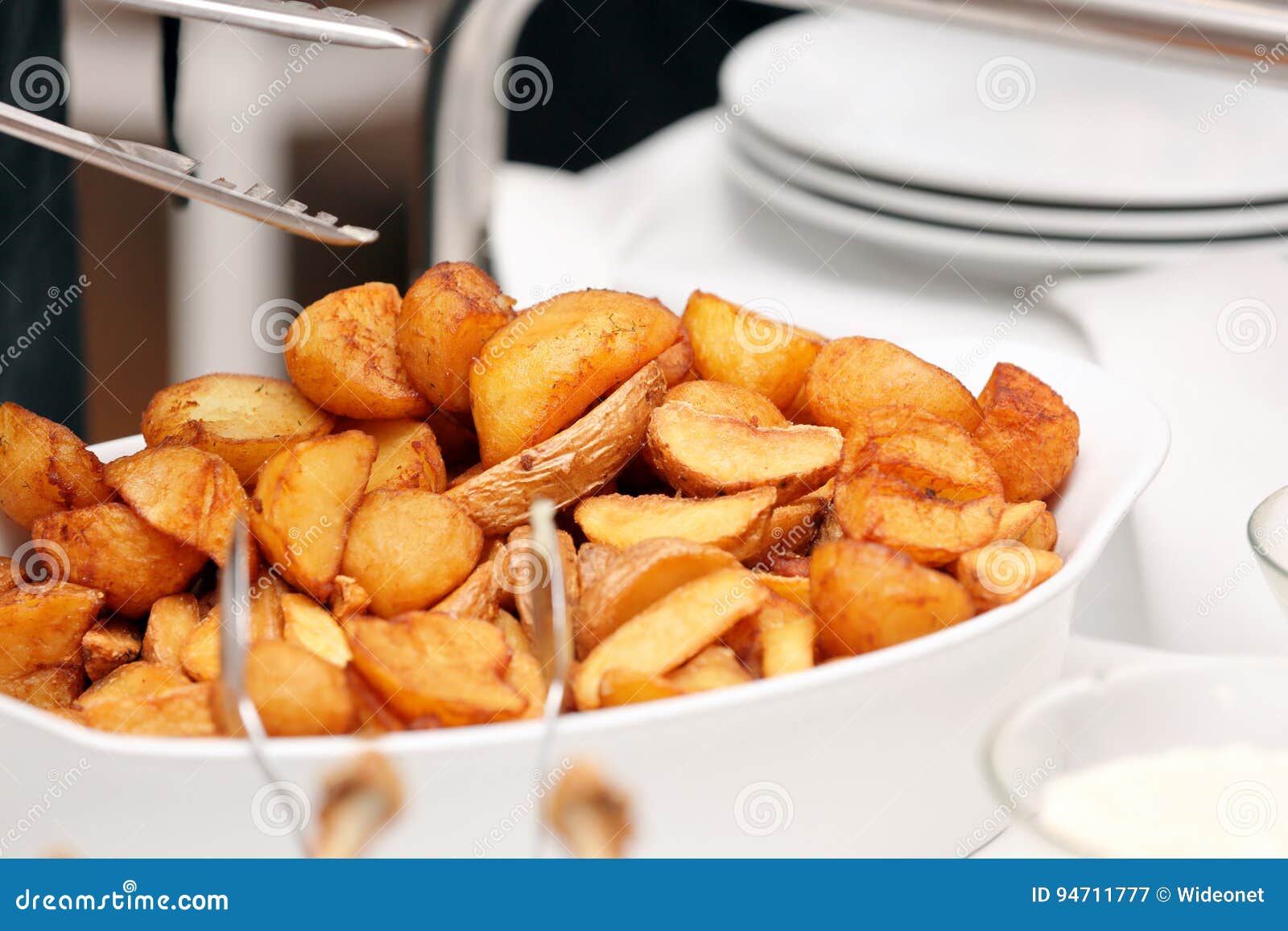 Waiter Serves Baked Potatoes at the Party Stock Image - Image of comber