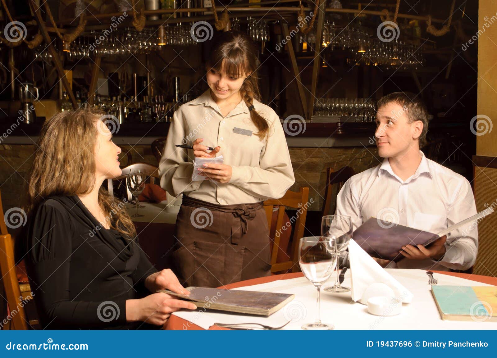 a waiter taking order from customers