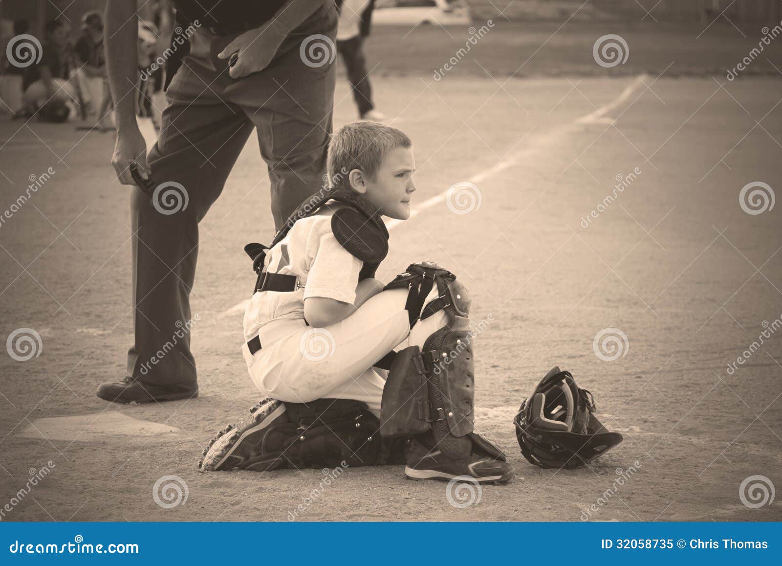 Waiting in Sepia. Baseball Catcher waiting for play to resume. In Sepia tone.