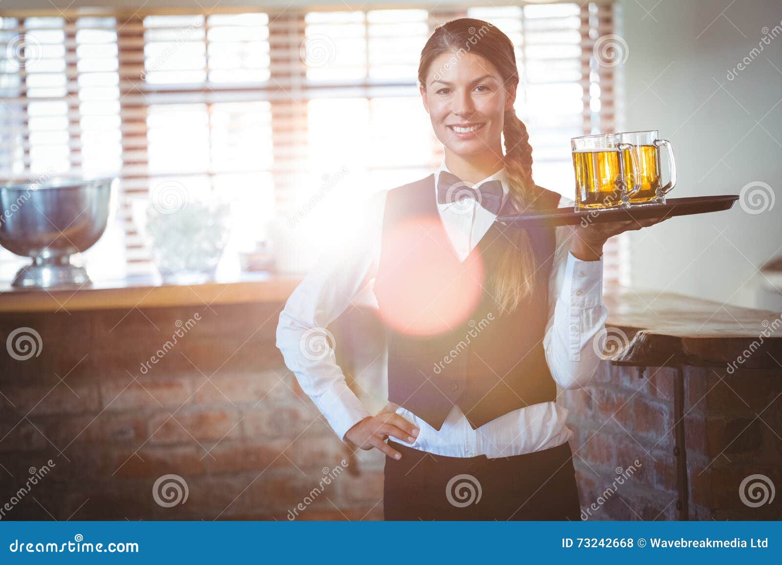 Waitress holding beers stock photo. Image of drink, hotel 73242668