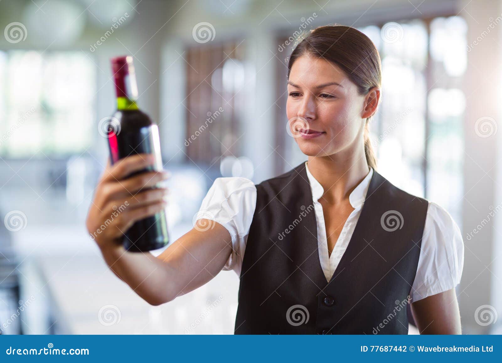Waitress Holding a Wine Bottle Stock Photo Image of hotel, waistcoat