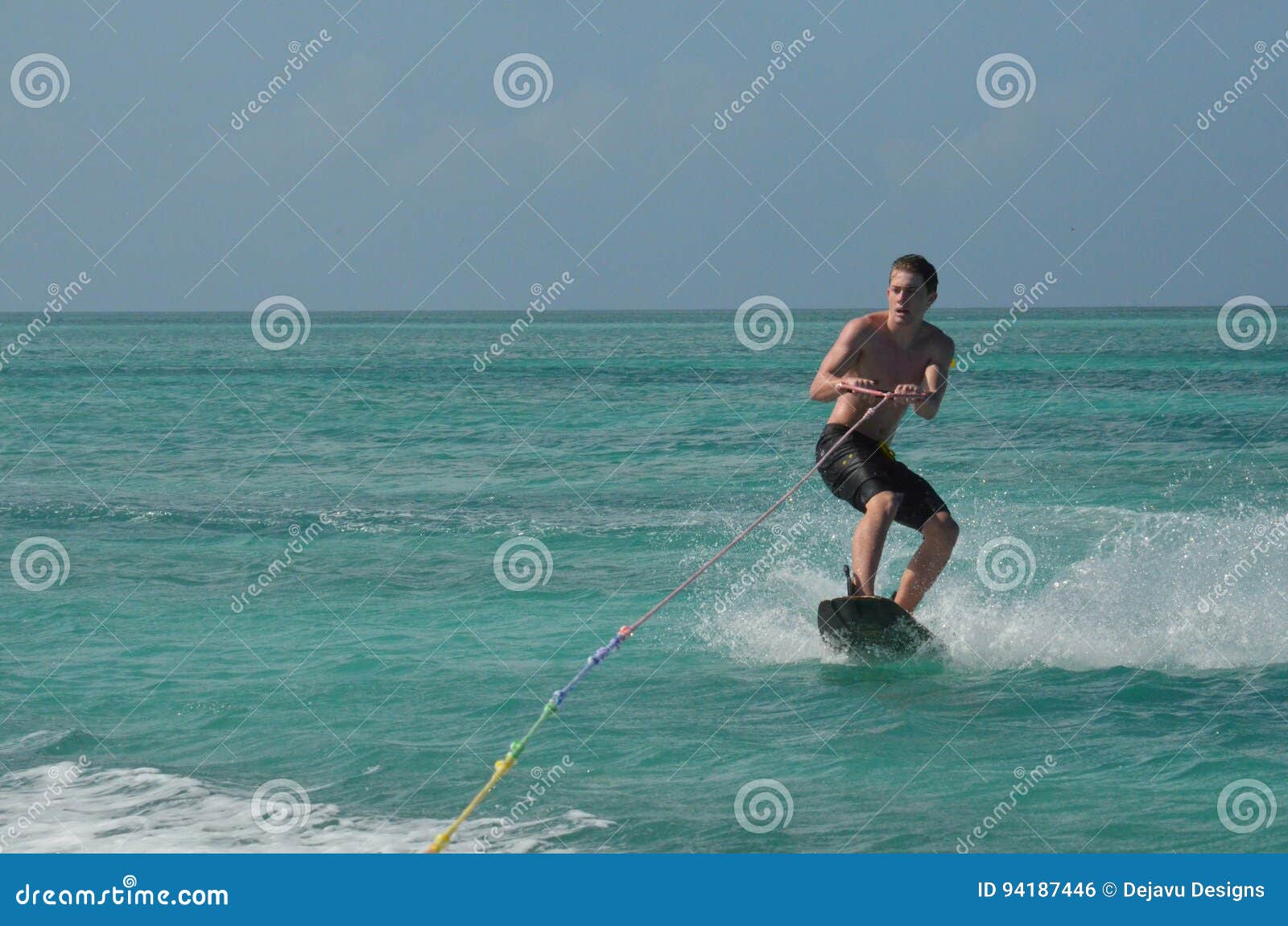 Wakeboarder Being Pulled by a Tow Rope on a Boat Stock Photo Image of board, young 94187446