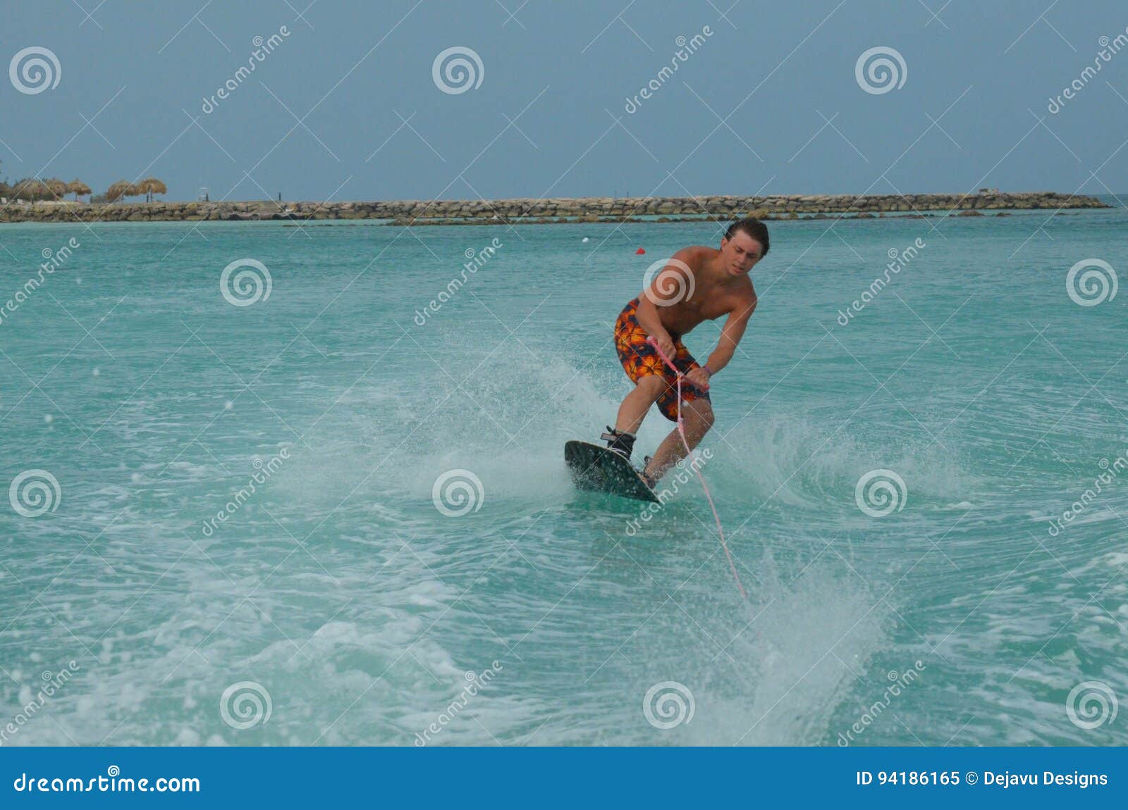 Wakeboarder Leaning into a Turn on a Wakeboard in Aruba Stock Image