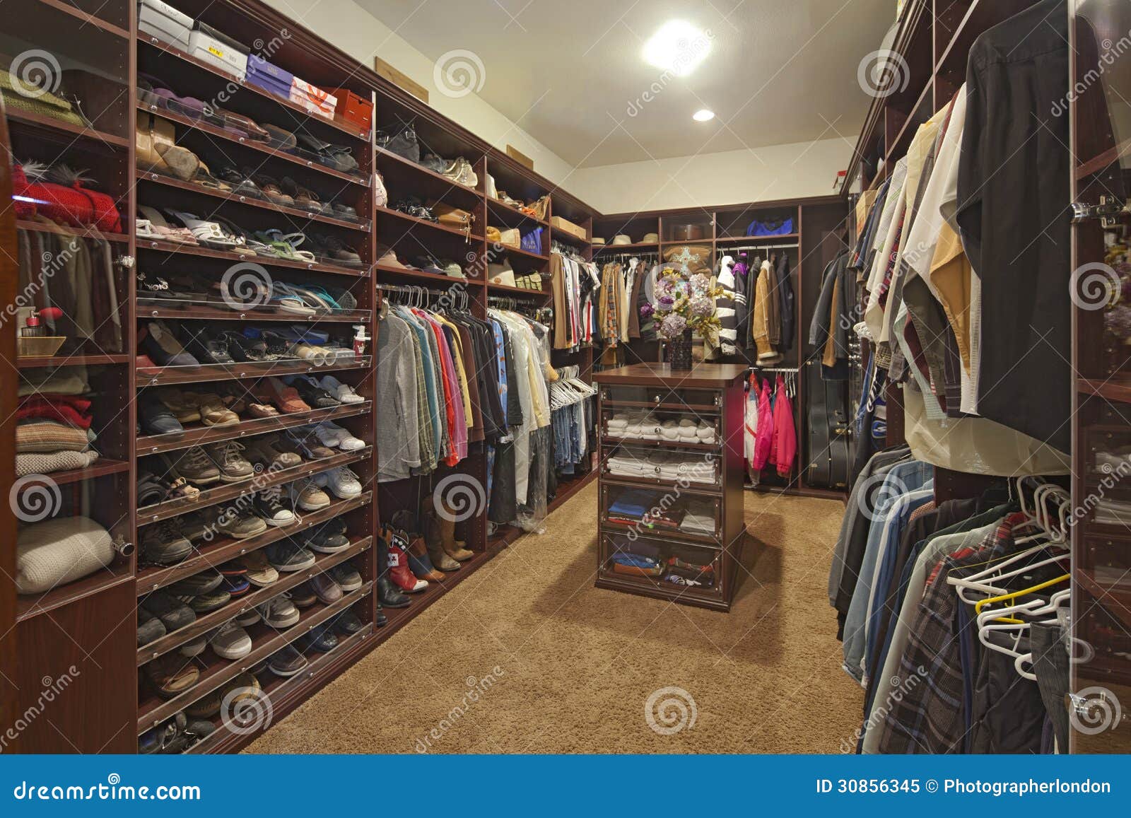 walk in closet with organized clothing
