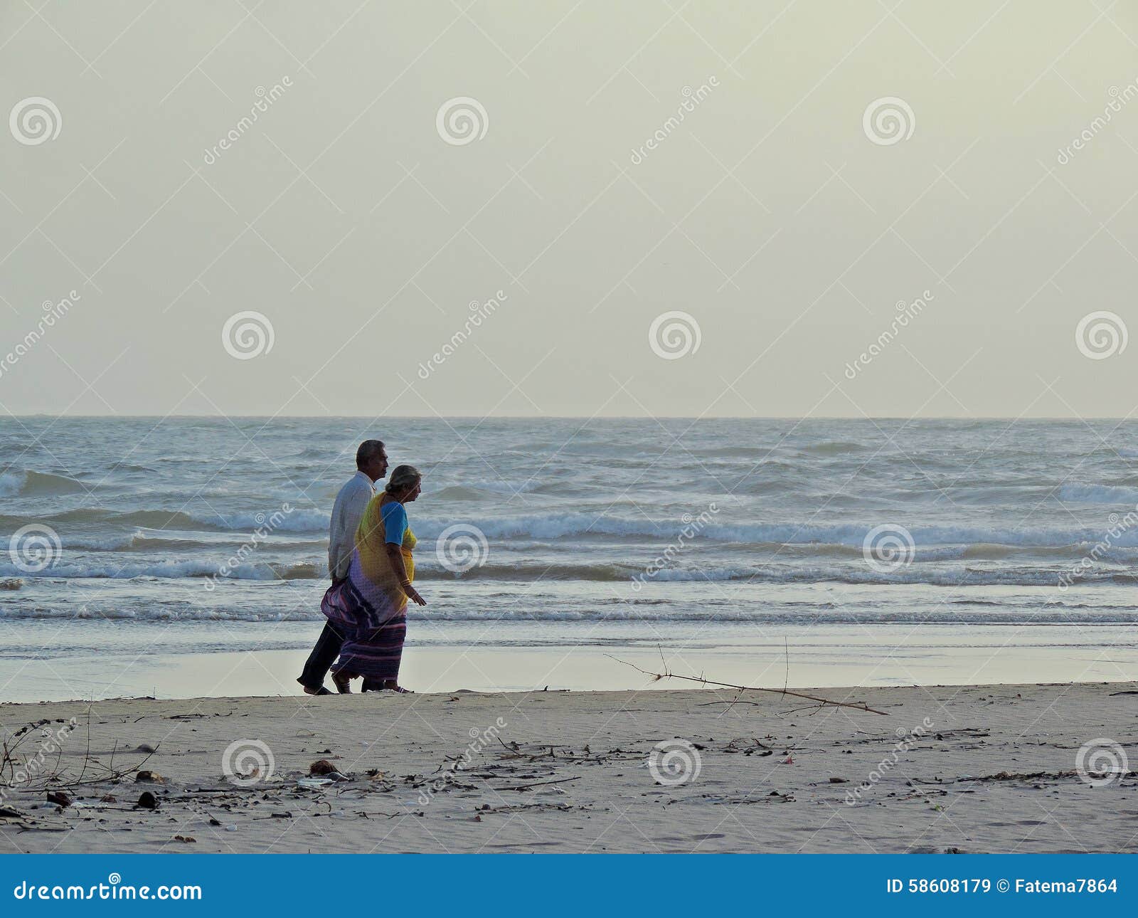 Old Couple Walking On Beach Editorial Image 31634154