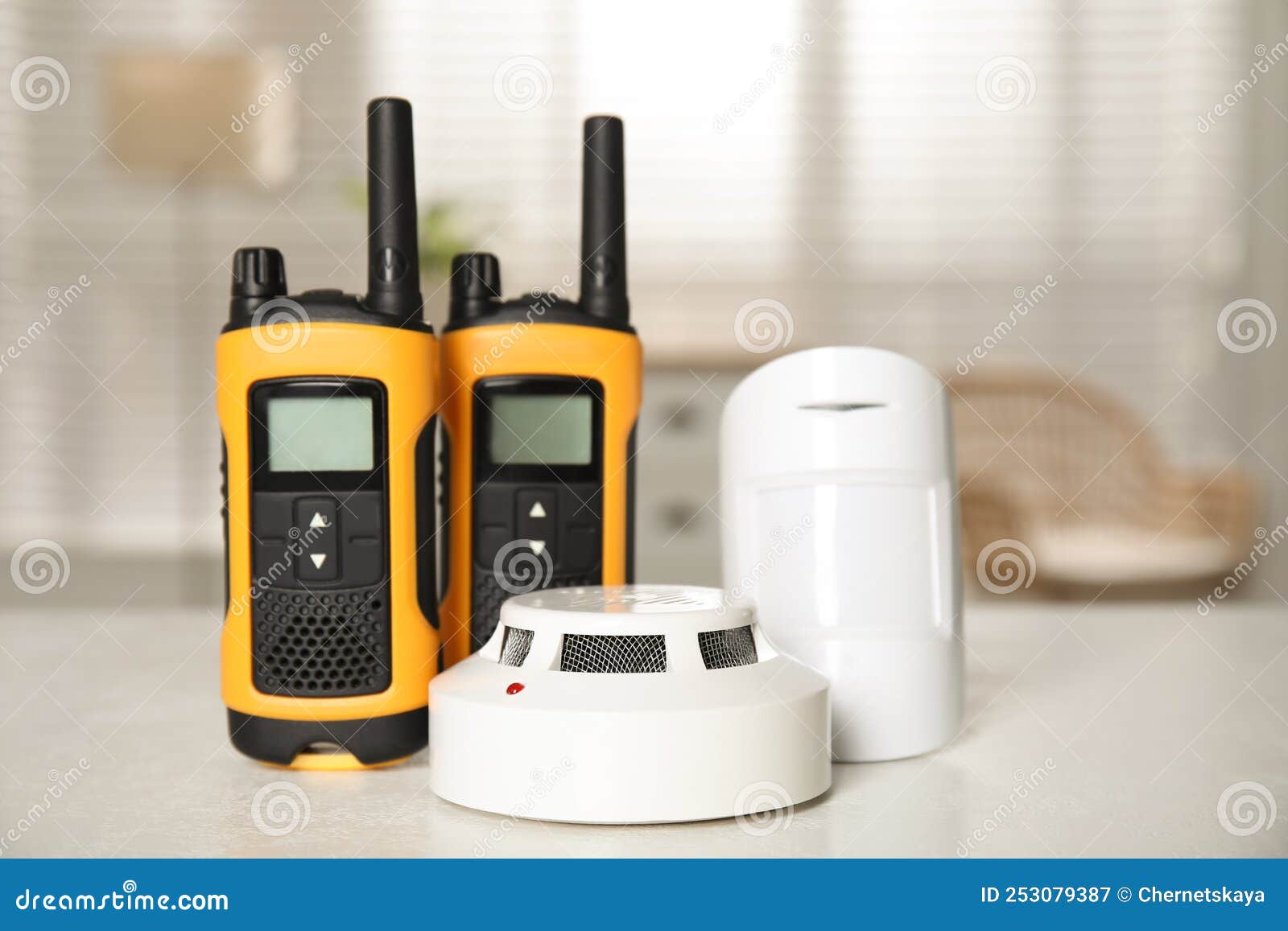 Walkie Talkies, Smoke and Movement Detectors on White Table Indoors
