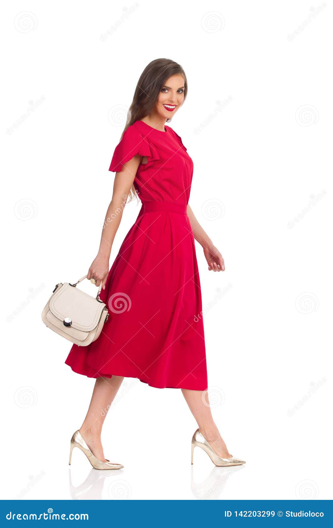 Walking Beautiful Woman in Elegant Red Dress, Gold High Heels and Beige ...